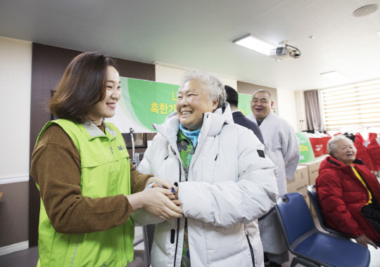 LS산전이 22일 안양 지역 독거노인과 장애인 등 취약계층 200명에 방한복을 전달하는 LS산전과 함께하는 온기 가득 방한복 나눔 행사를 했다. 사진은 지난해 LS산전 임직원봉사단원이 노인들께 방한복을 입혀드리는 모습. <LS산전 제공>